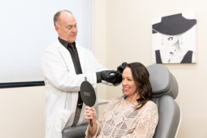 Co-founder Michael Johnson carefully inserts PDO threads near Blaine above a female client's brow. These dissolvable threads restore skin from the inside out, yielding a natural lift.