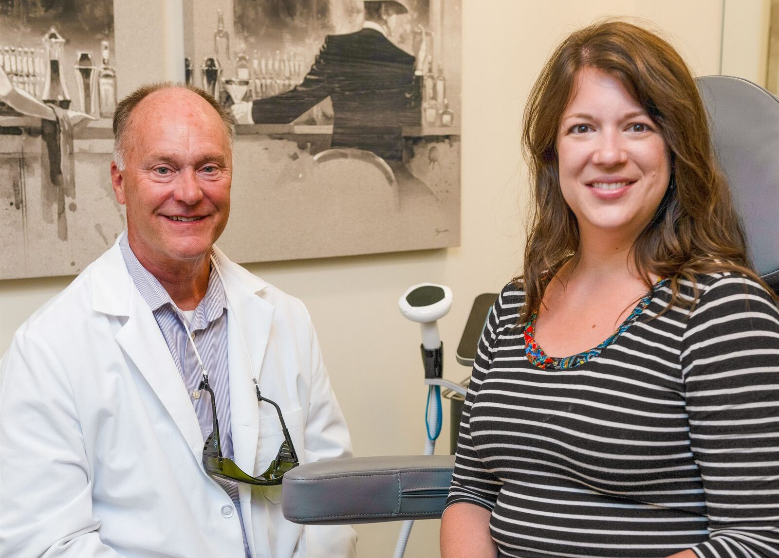 Michael Johnson, MA, FNP-BC with a client in a treatment room at Enrichment Skin Solutions in Brooklyn Park, Minnesota