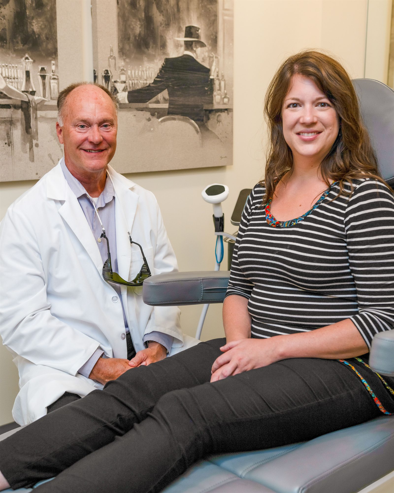 Michael Johnson, MA, FNP-BC with a client in a treatment room at Enrichment Skin Solutions in Brooklyn Park, Minnesota