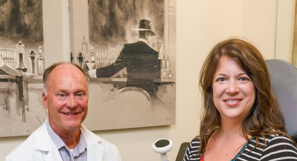 Michael Johnson, MA, FNP-BC with a client in a treatment room at Enrichment Skin Solutions in Brooklyn Park, Minnesota